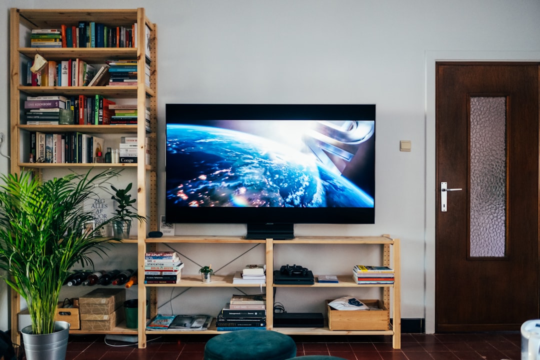 A television and media equipment on shelving in a living room